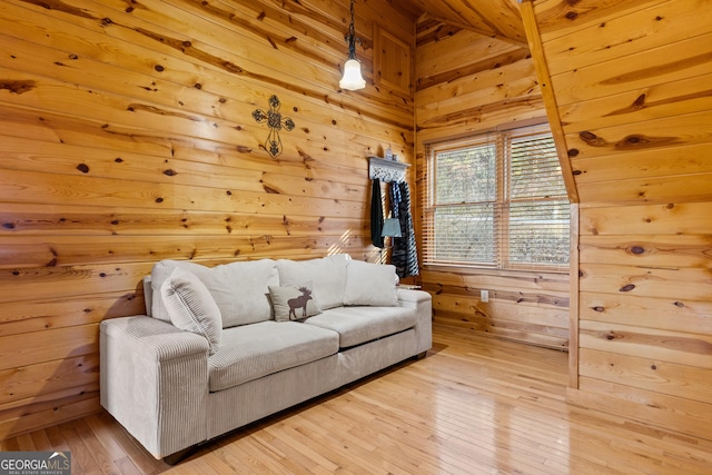 living room with hardwood / wood-style flooring and wooden walls