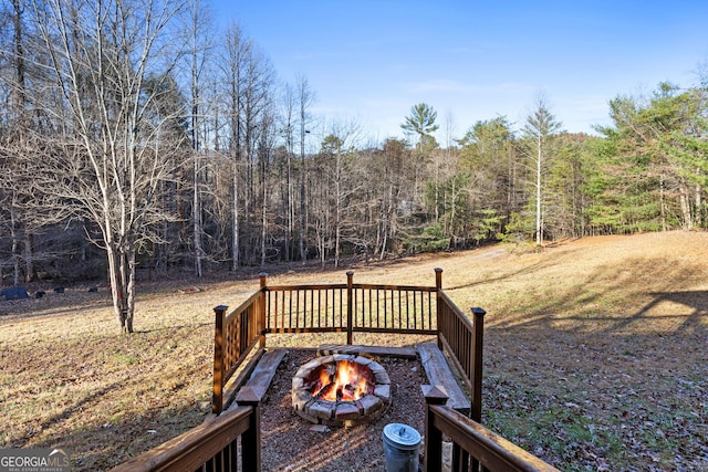 wooden terrace featuring a fire pit