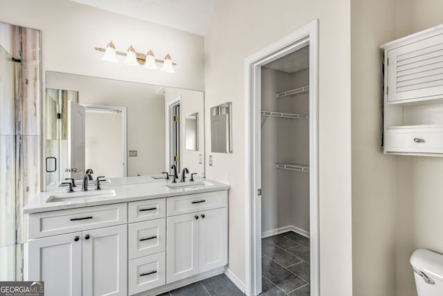 bathroom with tile patterned floors, vanity, a textured ceiling, and toilet