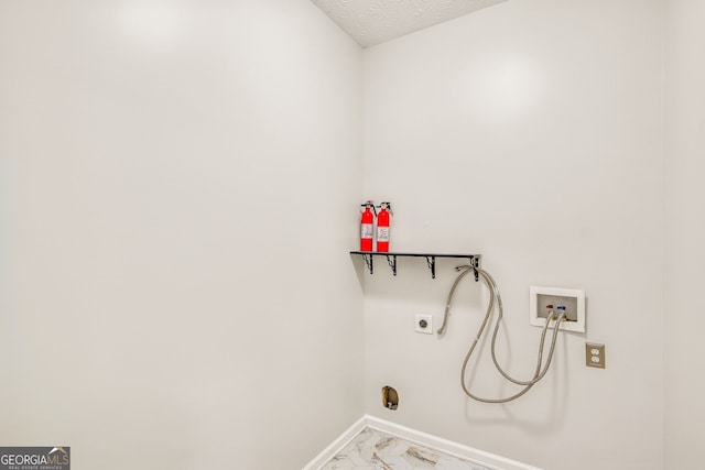 laundry area with washer hookup, a textured ceiling, and hookup for an electric dryer