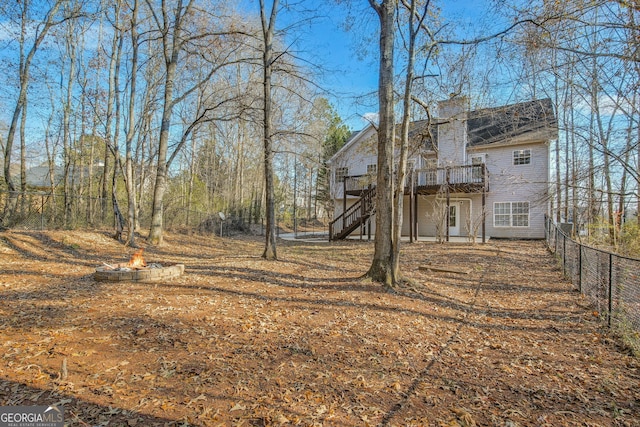 view of yard featuring a fire pit and a wooden deck