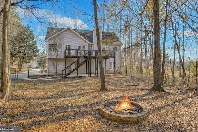 view of yard featuring a fire pit and a wooden deck