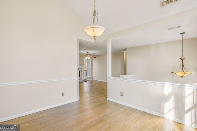 empty room featuring hardwood / wood-style floors and ceiling fan