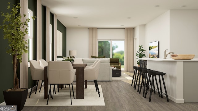 dining area with light hardwood / wood-style floors and sink