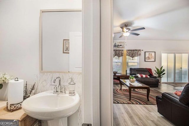 bathroom featuring ceiling fan, sink, hardwood / wood-style floors, and backsplash