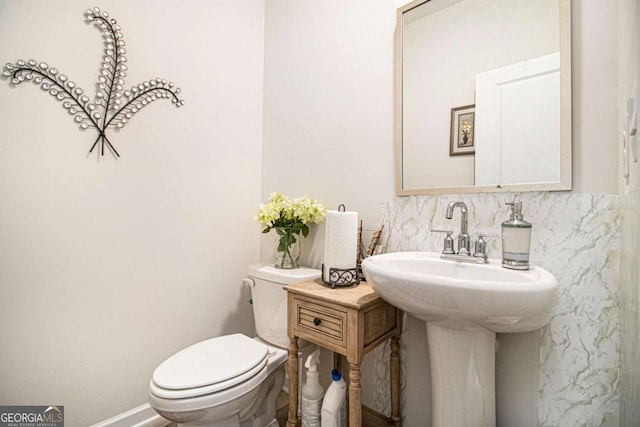 bathroom with toilet and decorative backsplash