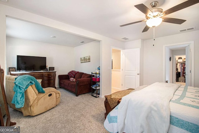 carpeted bedroom with ceiling fan, a closet, and a spacious closet