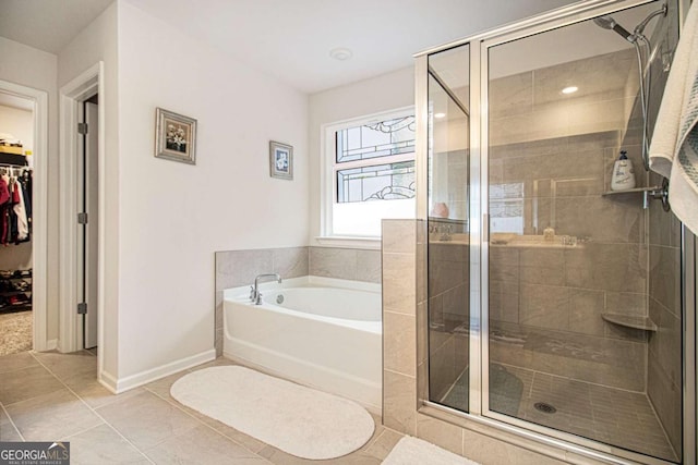 bathroom with independent shower and bath and tile patterned floors