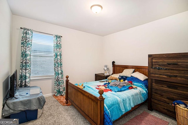 carpeted bedroom with wood walls