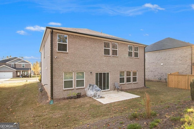 back of house featuring a patio area and a lawn