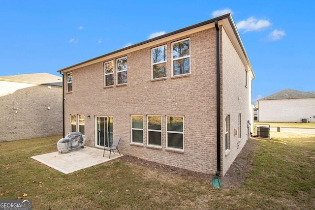 back of property with cooling unit, a yard, and a patio