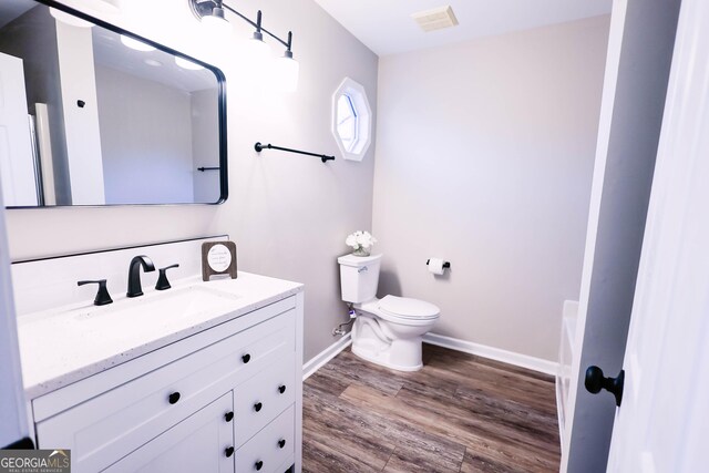 bathroom featuring hardwood / wood-style floors, vanity, and toilet