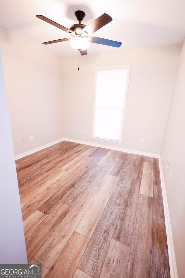 spare room with ceiling fan and light hardwood / wood-style flooring