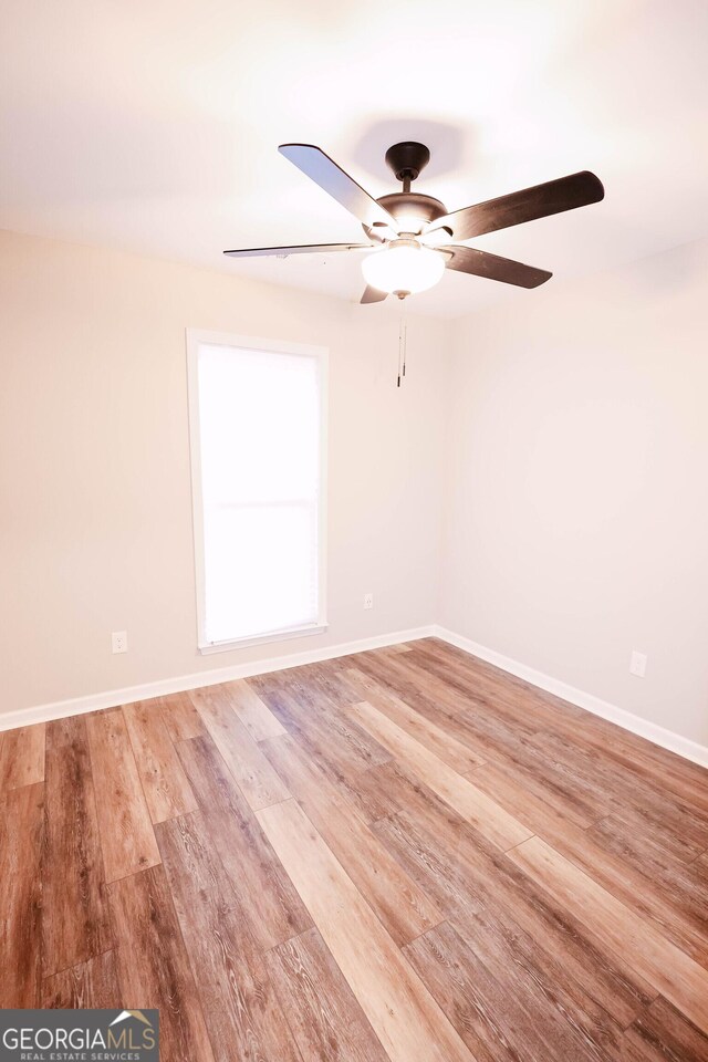 unfurnished room featuring ceiling fan and light hardwood / wood-style flooring