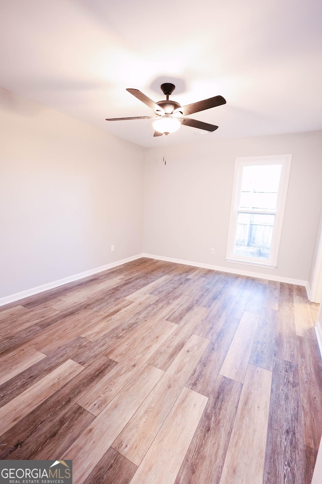 empty room with light hardwood / wood-style flooring and ceiling fan