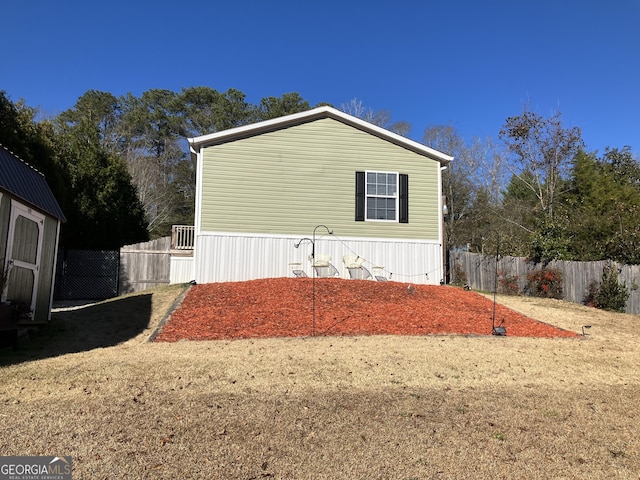 view of side of home with a shed