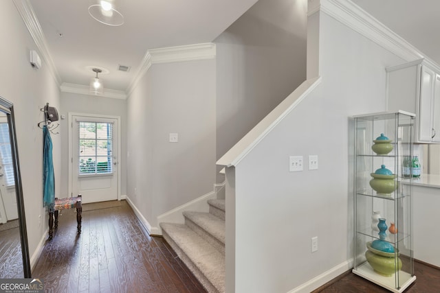 entrance foyer with dark hardwood / wood-style flooring and ornamental molding