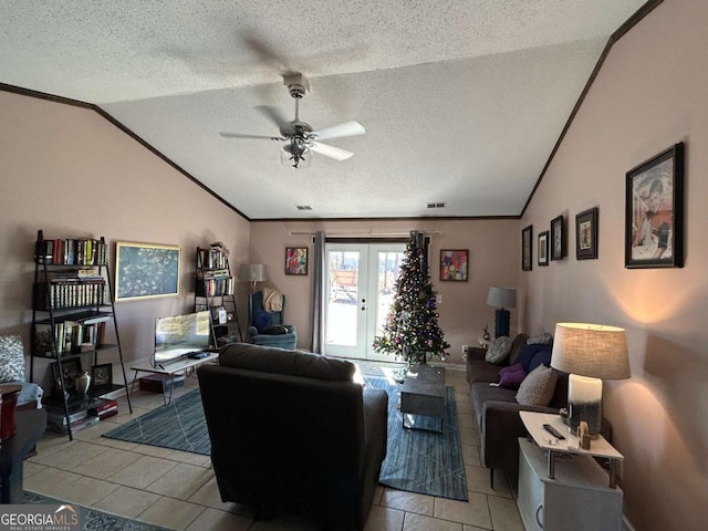 living room featuring french doors, a textured ceiling, ceiling fan, lofted ceiling, and light tile patterned flooring