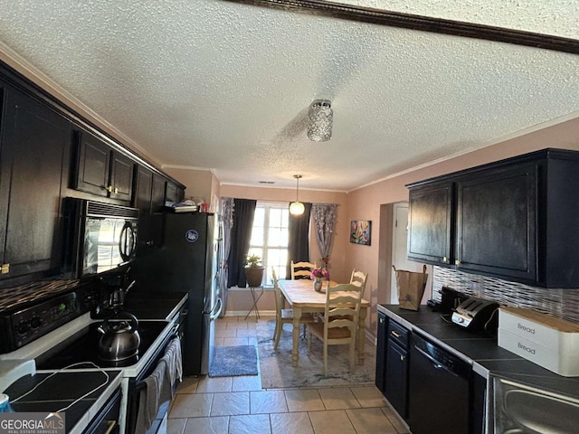 kitchen featuring hanging light fixtures, a textured ceiling, decorative backsplash, black appliances, and ornamental molding