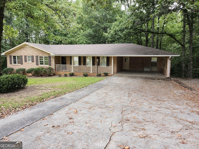 ranch-style house with covered porch and a carport