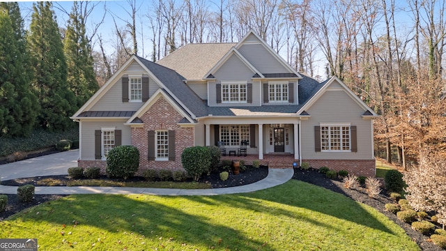 craftsman house with a porch and a front yard