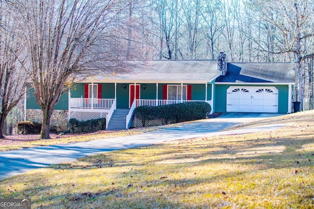 single story home with a porch, a garage, and a front lawn