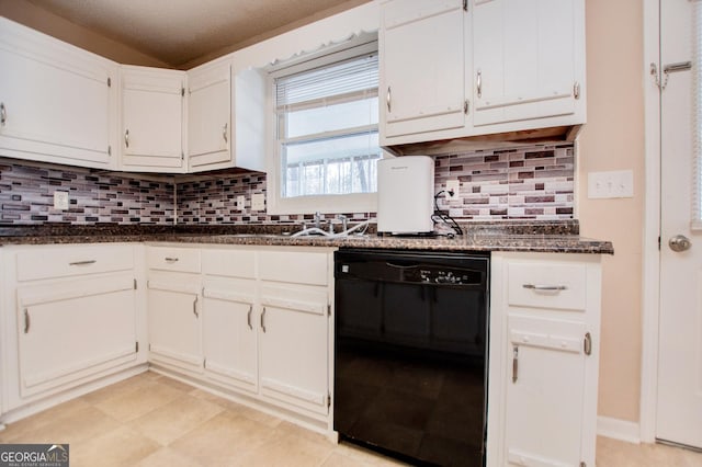 kitchen featuring backsplash, dark stone countertops, white cabinetry, and black dishwasher