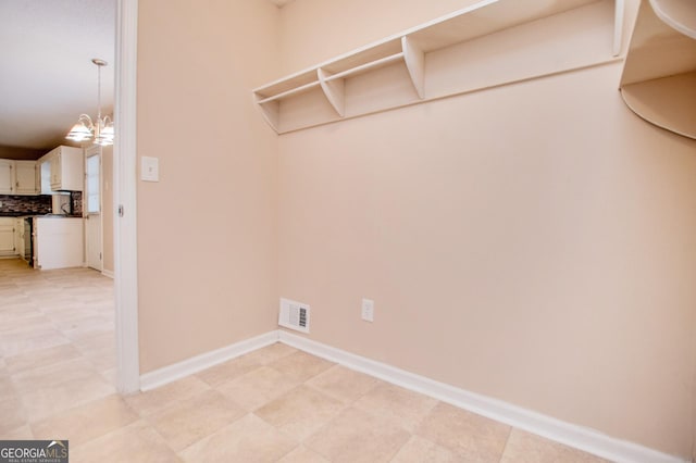 washroom featuring an inviting chandelier