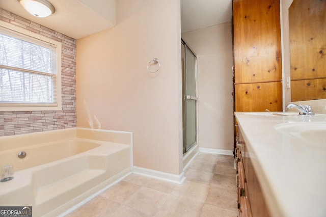 bathroom with vanity and independent shower and bath