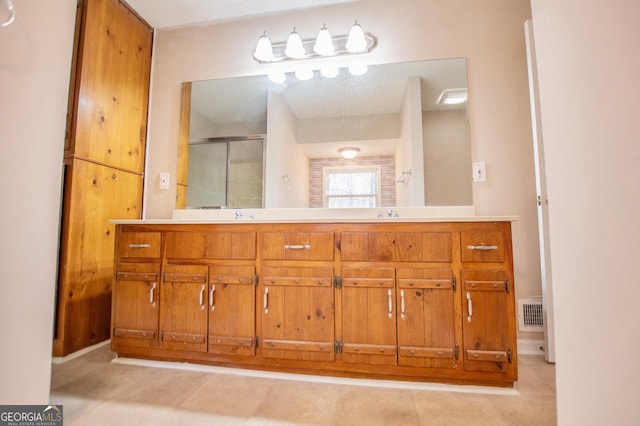 bathroom featuring vanity and a shower with shower door