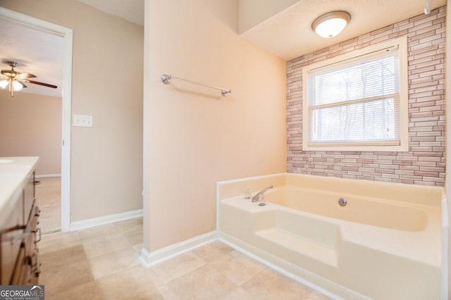 bathroom with a bath, vanity, a textured ceiling, and ceiling fan