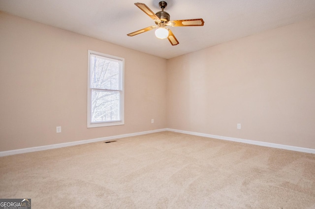 carpeted empty room featuring ceiling fan