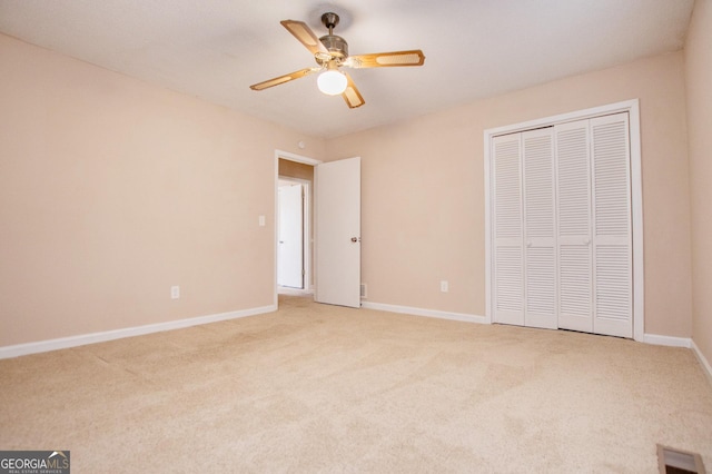 unfurnished bedroom featuring light carpet, a closet, and ceiling fan