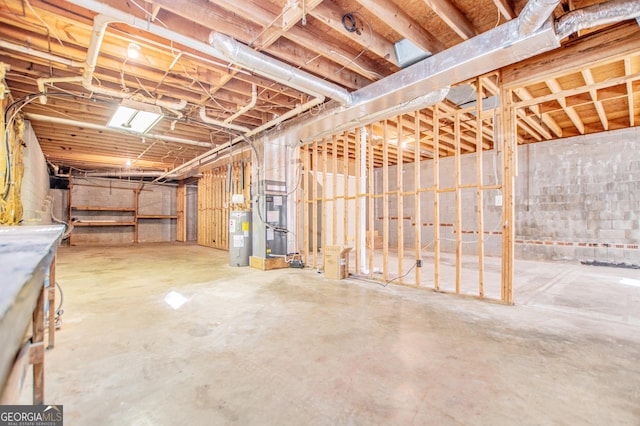 basement featuring heating unit and water heater