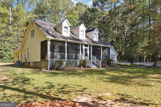 new england style home featuring central AC unit, a sunroom, and a front lawn