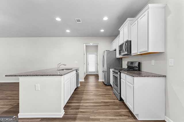 kitchen with white cabinets, sink, dark stone countertops, and stainless steel appliances