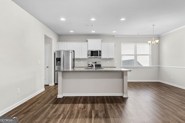 kitchen with white cabinetry, appliances with stainless steel finishes, a kitchen island with sink, and stone counters