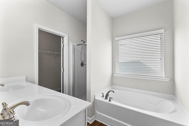 bathroom with independent shower and bath and vanity