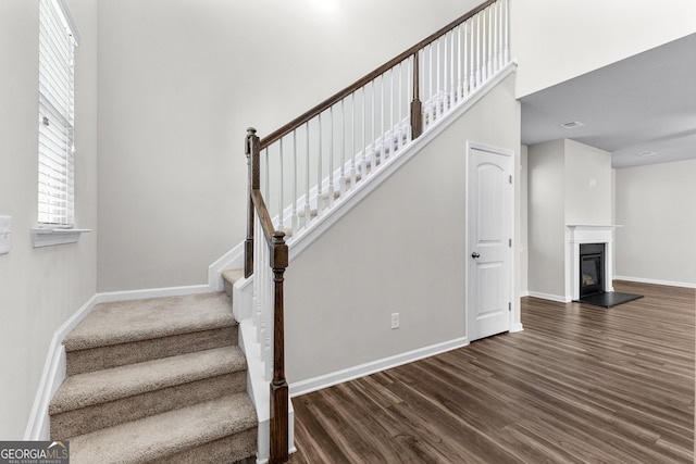 stairway with hardwood / wood-style floors