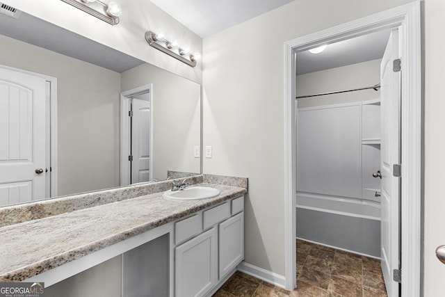 bathroom with vanity and shower / washtub combination