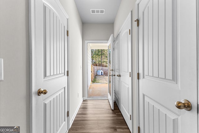 corridor with dark hardwood / wood-style floors