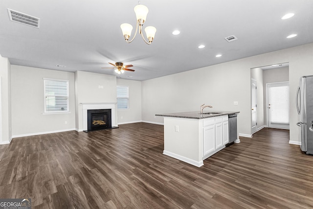 kitchen featuring white cabinetry, sink, plenty of natural light, dark hardwood / wood-style floors, and hanging light fixtures