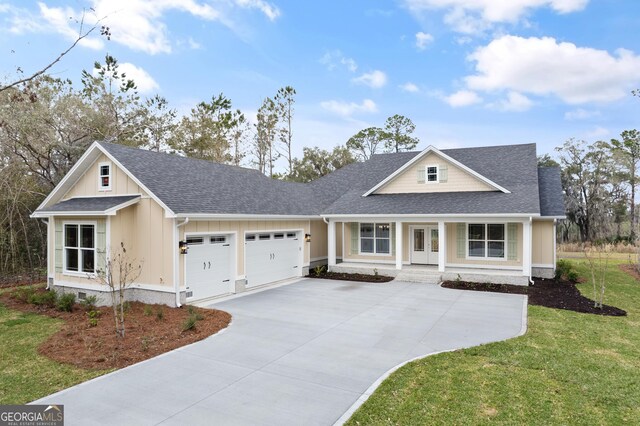 view of front of home with a garage and a front lawn