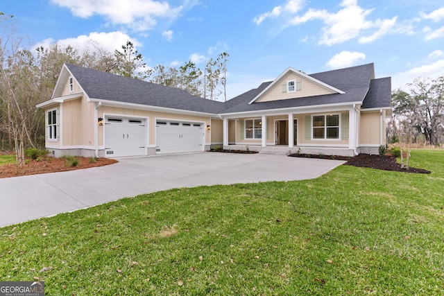 view of front of house with a garage, covered porch, board and batten siding, and a front lawn