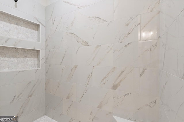 bathroom with a tile shower