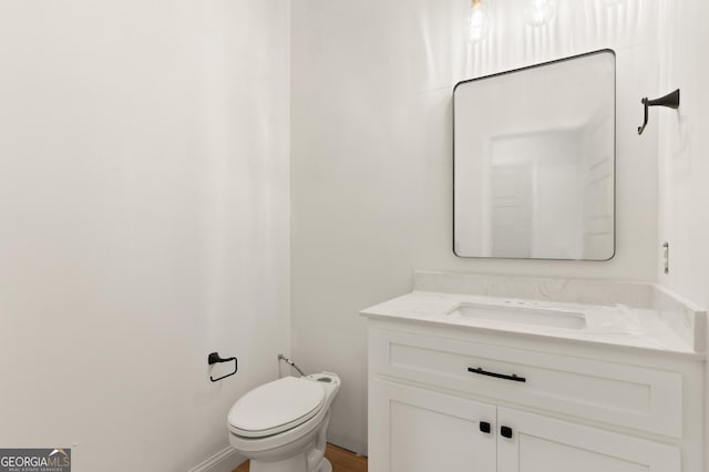 bathroom with toilet and vanity