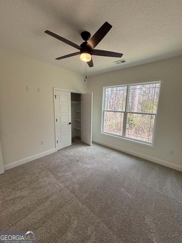 unfurnished bedroom with a closet, baseboards, visible vents, and carpet floors