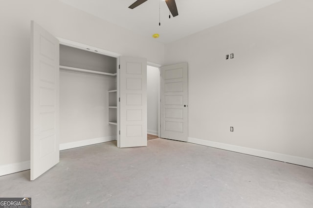 unfurnished bedroom featuring baseboards, a closet, and unfinished concrete floors