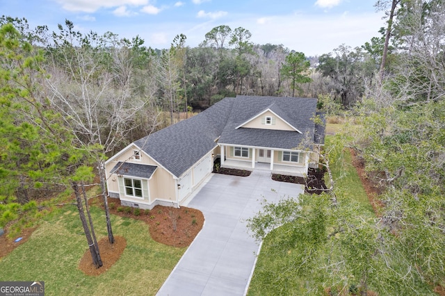 drone / aerial view featuring a wooded view