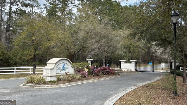 community sign with a gate and fence